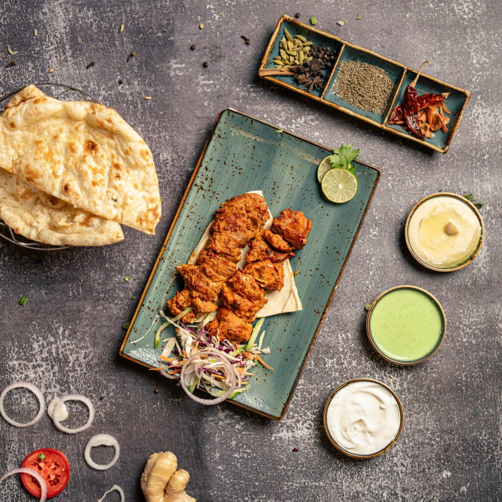 Tantalizing chicken mandi served with naan and an array of flavorful dips.
