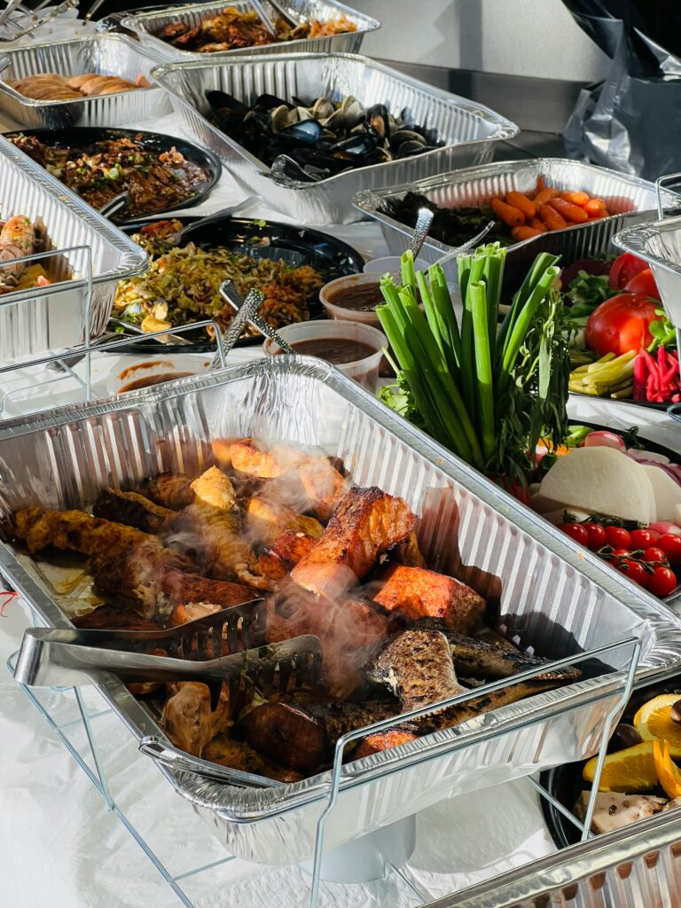 A spread of diverse and delicious dishes at a catered buffet showcasing a variety of cuisines.