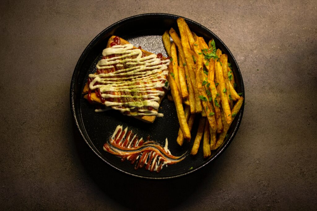 Delicious Iranian sandwich with crispy french fries garnished with parsley, perfect street food.