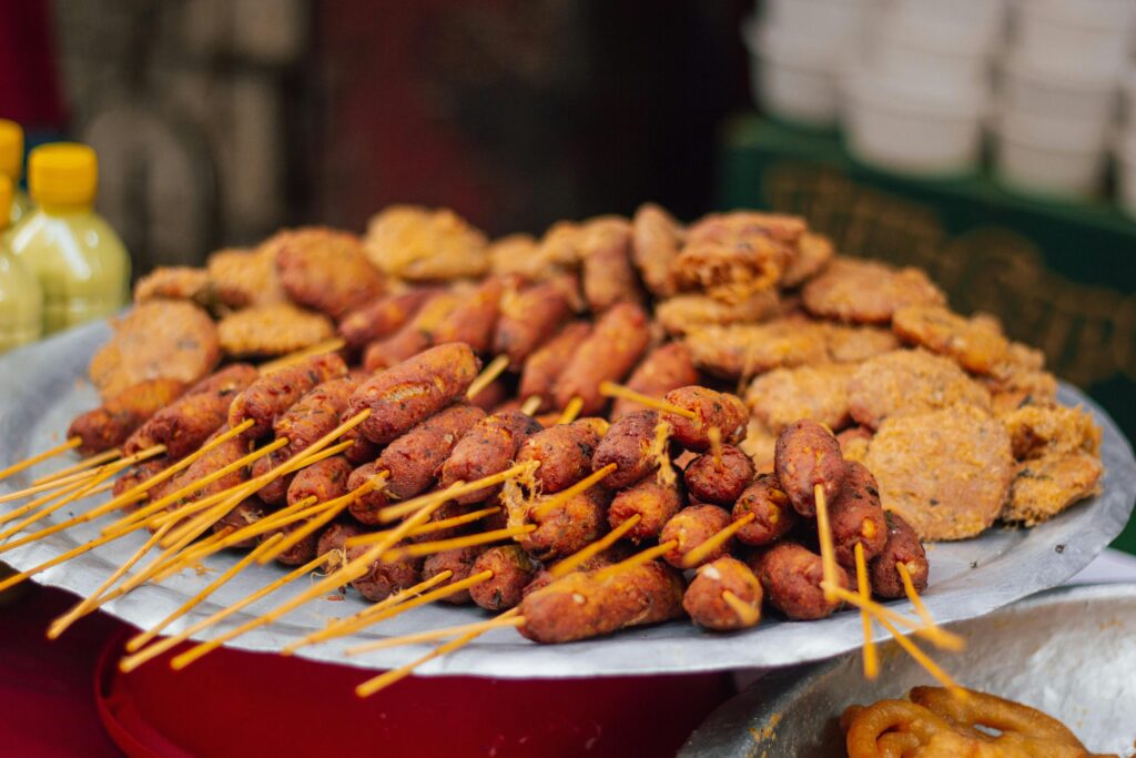 Tempting array of traditional Bangladeshi street food, featuring kebabs and savory fritters.